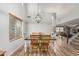 Bright dining room with high ceilings, a decorative chandelier, and wooden floors at 3528 E Tonto Dr, Gilbert, AZ 85298