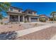Two-story home with desert landscaping, front porch and a two-car garage at 3528 E Tonto Dr, Gilbert, AZ 85298
