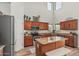 Kitchen with stainless steel appliances, wood cabinets, granite countertops, and a center island at 3528 E Tonto Dr, Gilbert, AZ 85298