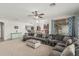 Open-concept living room with large sectional sofa and view to the upstairs landing and kitchen at 3528 E Tonto Dr, Gilbert, AZ 85298