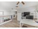 Upstairs loft space with wood-style floors, ceiling fan, desk and storage at 3528 E Tonto Dr, Gilbert, AZ 85298