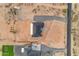 An aerial view of a modern home with a dark roof, surrounded by desert landscaping and a spacious lot at 35280 N Bell Rd, Queen Creek, AZ 85144