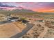 Desert property with a new home, long driveway and surrounded by mountain views at sunset at 35280 N Bell Rd, Queen Creek, AZ 85144