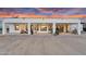 Spacious covered back patio with seating, ceiling fan, and desert views through large windows at 35280 N Bell Rd, Queen Creek, AZ 85144