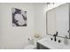 Powder room with modern vanity, updated faucet, and decorative artwork at 35280 N Bell Rd, Queen Creek, AZ 85144