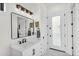 Bathroom featuring a modern vanity, framed mirror, and a view of the entrance door at 35280 N Bell Rd, Queen Creek, AZ 85144