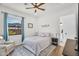 Cozy bedroom with a ceiling fan, window with neighborhood views and sitting area with door to bathroom at 35280 N Bell Rd, Queen Creek, AZ 85144