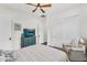Bedroom features a ceiling fan, a TV above chest and large closets and sitting area at 35280 N Bell Rd, Queen Creek, AZ 85144