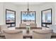 Elegant dining room boasts bright windows offering views of the desert landscape at 35280 N Bell Rd, Queen Creek, AZ 85144