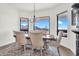 Elegant dining area with six chairs and view of desert mountain range at 35280 N Bell Rd, Queen Creek, AZ 85144