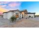 Charming exterior with stone accents, stylish lighting, and desert landscaping, creating an inviting curb appeal at 35280 N Bell Rd, Queen Creek, AZ 85144