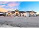 Striking single-Gathering home with stone accents and a covered entryway, blending elegance and charm at 35280 N Bell Rd, Queen Creek, AZ 85144