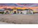 Beautiful modern home exterior featuring stone accents, desert landscaping, and a covered entryway at 35280 N Bell Rd, Queen Creek, AZ 85144