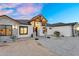 Charming single-Gathering home with stone accents, a covered porch, and professional landscaping at 35280 N Bell Rd, Queen Creek, AZ 85144