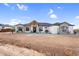 Welcoming front view of home featuring stone accents, desert landscaping, and covered entryway at 35280 N Bell Rd, Queen Creek, AZ 85144