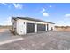 Spacious three-car garage with modern doors and ample parking space on a well-maintained driveway at 35280 N Bell Rd, Queen Creek, AZ 85144