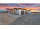 Stunning three-car garage exterior, well lit with stylish sconces at 35280 N Bell Rd, Queen Creek, AZ 85144