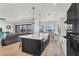Open concept kitchen features a large island with seating, seamless transition to living room, and stunning views at 35280 N Bell Rd, Queen Creek, AZ 85144