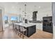 Bright, modern kitchen features a large island, pendant lighting, and stainless steel appliances at 35280 N Bell Rd, Queen Creek, AZ 85144