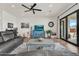 Comfortable living room features gray sofas, piano, stylish furnishings, and bright lighting at 35280 N Bell Rd, Queen Creek, AZ 85144