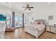 Spacious main bedroom with backyard access, plush bed, and light gray furnishings at 35280 N Bell Rd, Queen Creek, AZ 85144