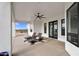 Relaxing covered patio with lounge chairs and mountain views, enhanced by a stylish ceiling fan at 35280 N Bell Rd, Queen Creek, AZ 85144