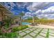 Inviting backyard with a sparkling pool, covered patio, lounge seating, and well-maintained greenery at 3954 E Becker Ln, Phoenix, AZ 85028