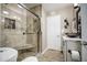 Updated bathroom featuring a stone shower and granite countertop sink at 3954 E Becker Ln, Phoenix, AZ 85028