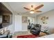 A cozy bedroom featuring a ceiling fan, a recliner, and a mirrored closet for ample storage at 3954 E Becker Ln, Phoenix, AZ 85028