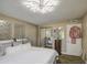 Bright bedroom with modern lighting and decor and a view of the sliding glass door at 3954 E Becker Ln, Phoenix, AZ 85028