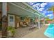 Relaxing covered patio with comfortable seating, adjacent to the pool, ideal for outdoor gatherings at 3954 E Becker Ln, Phoenix, AZ 85028