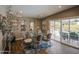 Stylish dining room with a glass table, seating for six, and access to a backyard pool area at 3954 E Becker Ln, Phoenix, AZ 85028