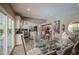 Open-concept dining room featuring a modern glass table and views of the kitchen at 3954 E Becker Ln, Phoenix, AZ 85028