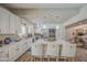 Well-lit kitchen with white cabinets, stainless steel appliances, granite countertops, and breakfast bar seating at 3954 E Becker Ln, Phoenix, AZ 85028