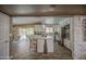 Bright kitchen with a center island, white cabinets, stainless steel appliances, and tile backsplash at 3954 E Becker Ln, Phoenix, AZ 85028
