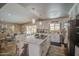 Modern kitchen with white cabinetry, stainless steel appliances, and a central island with pendant lighting at 3954 E Becker Ln, Phoenix, AZ 85028