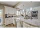 Bright kitchen featuring stainless steel appliances, custom cabinets, and a center island with barstool seating at 3954 E Becker Ln, Phoenix, AZ 85028