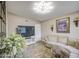 Cozy living room with wood floors, tan sofa, and a decorative TV stand at 3954 E Becker Ln, Phoenix, AZ 85028