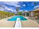 Private pool with diving board surrounded by mature trees and a covered patio for ultimate relaxation at 3954 E Becker Ln, Phoenix, AZ 85028