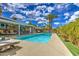 Serene pool area with inviting blue water, poolside seating, and lush landscaping at 3954 E Becker Ln, Phoenix, AZ 85028