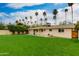 Spacious backyard with well-maintained lawn, block fence, mature trees, and covered patio at 4201 N 35Th St, Phoenix, AZ 85018