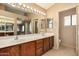 Bathroom with dual sinks, large mirror, and ensuite bathroom views at 4212 W Jason Dr, Glendale, AZ 85308