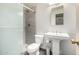 Bathroom featuring glass enclosed walk-in shower, pedestal sink, toilet, and modern finishes at 4212 W Jason Dr, Glendale, AZ 85308
