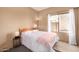 Bedroom with neutral colors, lamp, bedside table and sunlit window view at 4212 W Jason Dr, Glendale, AZ 85308