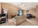 Large bedroom featuring a tan sofa, a ceiling fan, and a large window at 4212 W Jason Dr, Glendale, AZ 85308