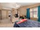Spacious bedroom with ceiling fan, sofa, and private bathroom access at 4212 W Jason Dr, Glendale, AZ 85308