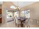 Cozy dining area with a wooden table, seating for six, sliding glass doors, and tile flooring at 4212 W Jason Dr, Glendale, AZ 85308