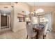 Cozy dining area with pendant lighting and easy access to the kitchen and outdoor patio through sliding glass doors at 4212 W Jason Dr, Glendale, AZ 85308