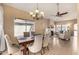 Inviting dining room with a wooden table, upholstered chairs, chandelier, and views to the fireplace and living area at 4212 W Jason Dr, Glendale, AZ 85308
