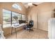 Bright home office with tiled floors, ceiling fan, a large window, and sliding closet doors at 4212 W Jason Dr, Glendale, AZ 85308